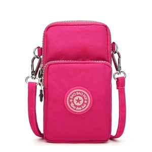 Vertical rose red nylon cell phone crossbody bag with double zippers and fabric strap