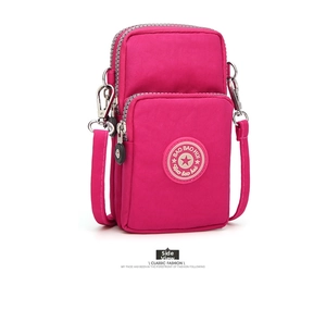 Detailed side view of rose red nylon crossbody phone bag with multi-layer zippers
