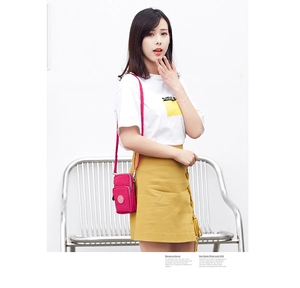 Detailed view of magenta multi-zipper crossbody phone bag with adjustable strap