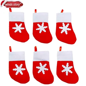 Set of 6 classic red and white Christmas stocking cutlery holders with snowflake detail