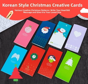 Flat lay of 3D wing heart Christmas cards in eight colorful festive patterns
