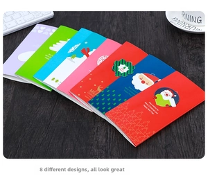Close-up of variety Christmas cards featuring 8 festive patterns on dark wood surface