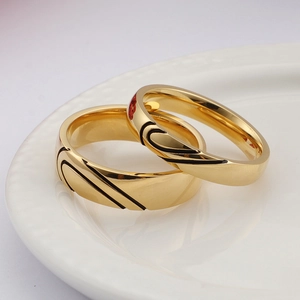 Polished gold stainless steel couple rings set with black heart and red flower detail