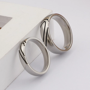 Polished silver titanium steel couple rings featuring minimalist black heart patterns