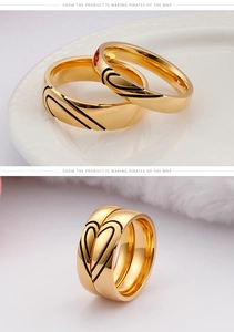 Detail of interlocking gold heart pattern on polished stainless steel couple rings