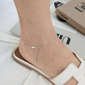 Minimalist S925 sterling silver snake bone chain anklet worn on model with tag