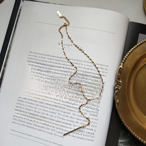 Elegant 925 sterling silver gold lip chain necklace displayed on an artistic book background