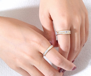 Close-up of Forever Love couple rings with gold interior and heart-shaped diamond inlay