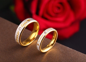 Macro shot of 18K gold-plated forever love rings with cubic zirconia and heart motifs