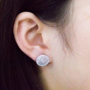 Sparkling silver flower stud earrings with pave cubic zirconia on female model
