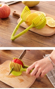 Detail showing the green slicer tool cutting a fresh tomato on a wooden board