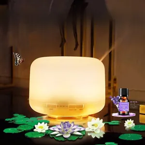 Detail of ultrasonic aroma diffuser with control buttons and lavender essential oil bottle