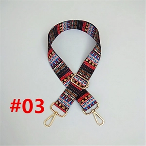 Close-up of ethnic style woven bag strap with golden hardware and geometric pattern