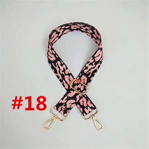 Detail of adjustable leopard print bag strap in pink and black with gold metal hardware