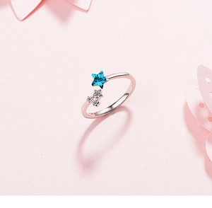 Detail of blue star gemstone and sparkling accents on silver open ring band