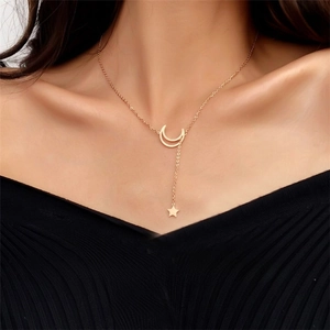 Detail of adjustable rose gold star and moon necklace with pull-to-style function