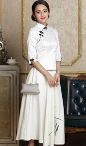 Silberne gewebte Abendtasche gehalten von Model in traditionellem weißem Blumenkleid
