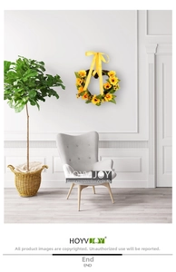 Couronne de tournesols en forme de cœur sur mur blanc avec détail de nœud en soie