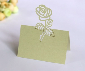 Detailed laser-cut 3D rose pattern on light green pearlescent cardstock wedding table card
