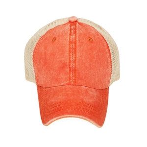 Detail of vintage washed orange cotton front and beige mesh back on a trucker hat