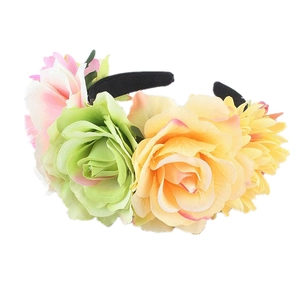 Detailed close-up of vibrant artificial rose petals and fabric texture on a party headband