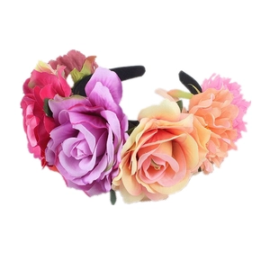 Close-up of vibrant artificial silk roses in magenta, orange and purple on a headband