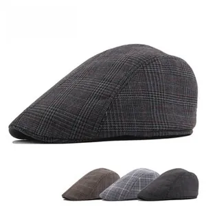 Detail view of vintage plaid flat caps for men in grey and brown wool texture patterns