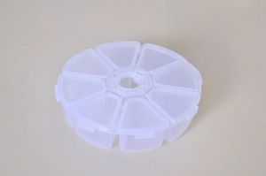 Close-up of 8-compartment round jewelry box with removable dividers and transparent lid