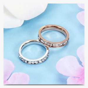 Close-up of 4mm silver and rose gold stainless steel rings with sparkling cubic zirconia