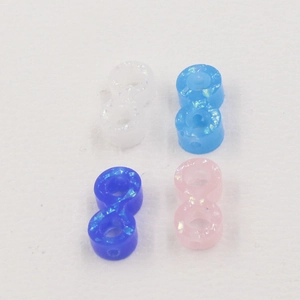 Detailed view of 1.5mm synthetic opal beads in white, blue, and pink for DIY jewelry