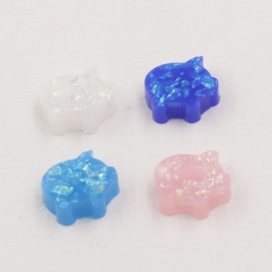 Macro detail of colorful pig-shaped opal loose beads for DIY jewelry making