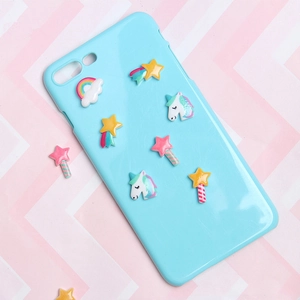 Detail view of light blue phone case featuring 3D resin unicorn and rainbow decorations