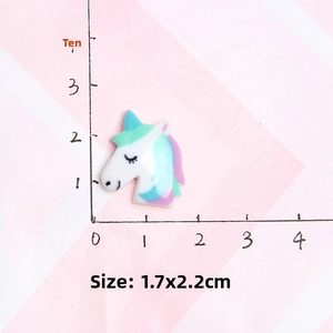 Macro view of 1.7x2.2cm resin unicorn charm with size measurement scale