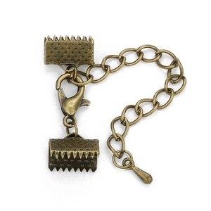 Macro detail of bronze lobster clasps and ribbon crimps jewelry making set