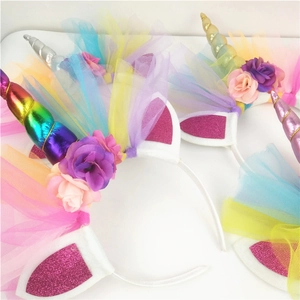 Close-up of glitter unicorn horns and sequin ears on colorful floral headbands