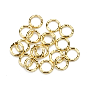 Macro shot of gold stainless steel open jump rings for DIY jewelry making and assembly