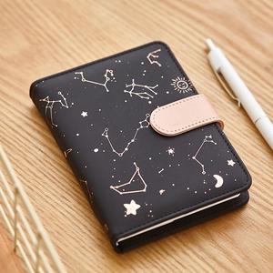 Star-themed faux leather notebook with gold constellation patterns and pink snap closure