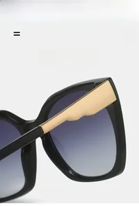 Detail of square sunglasses with purple gradient lenses and gold metallic temples