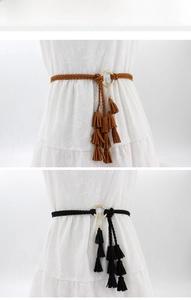 Detail of woven waist belts with golden metal rings and multi-layer fringe tassels