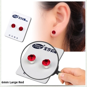Detail view of 6mm red crystal magnetic earring with size measurement and model display