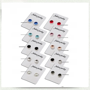 Detailed display of 10 magnetic crystal and pearl earrings on fashion jewelry cards