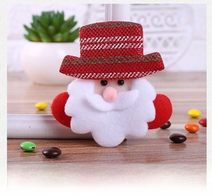 Close-up of a festive Santa Claus LED brooch with red glitter hat and fluffy white beard