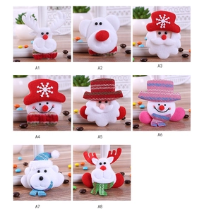 Close-up of assorted LED plush Christmas brooches featuring Santa, reindeer, and snowman