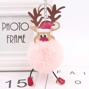 Detail of pink plush Christmas reindeer keychain with festive hat and silver metal ring