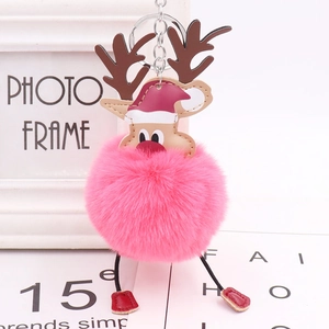 Pink plush reindeer pom pom keychain with red Santa hat and leather paws for bag charm