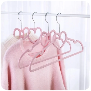 Detail of pink heart and bow plastic hangers showing non-slip sweater hanging scene