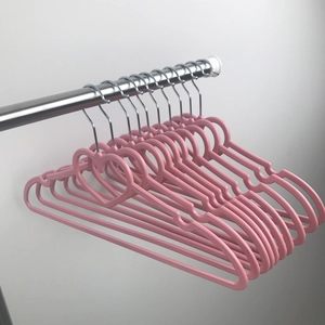 Pink heart-shaped plastic hanger with non-slip notches and metal swivel hook detail