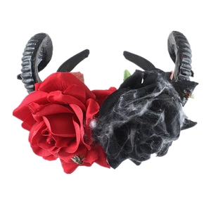 Close-up of gothic Halloween headband with black sheep horns, roses, and fake spiders