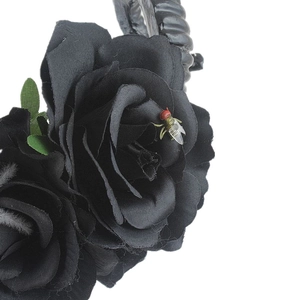 Detail of black artificial roses with realistic fly decor and gothic horns on headband