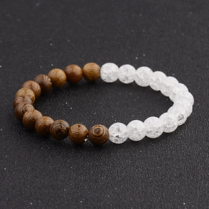 Detailed view of handmade beaded bracelet with dark wood grain and white cracked pattern beads